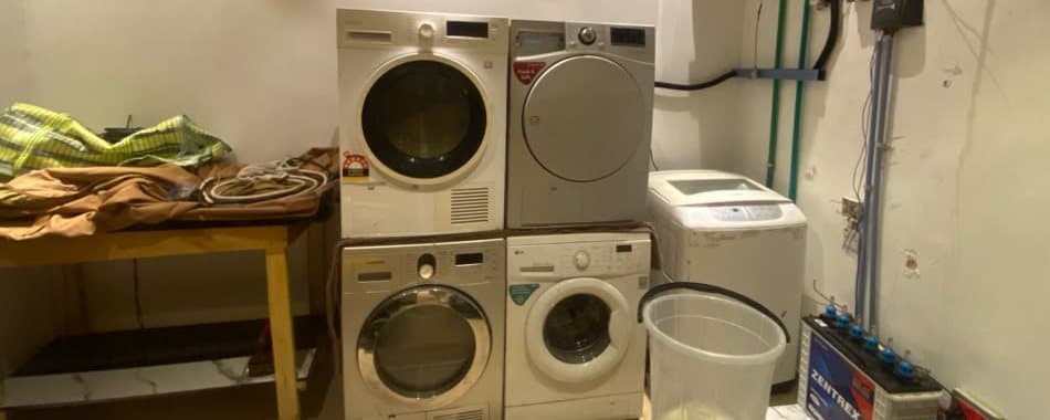 Front-loading washing machines at the Maventhin laundry in Iyana Isashi